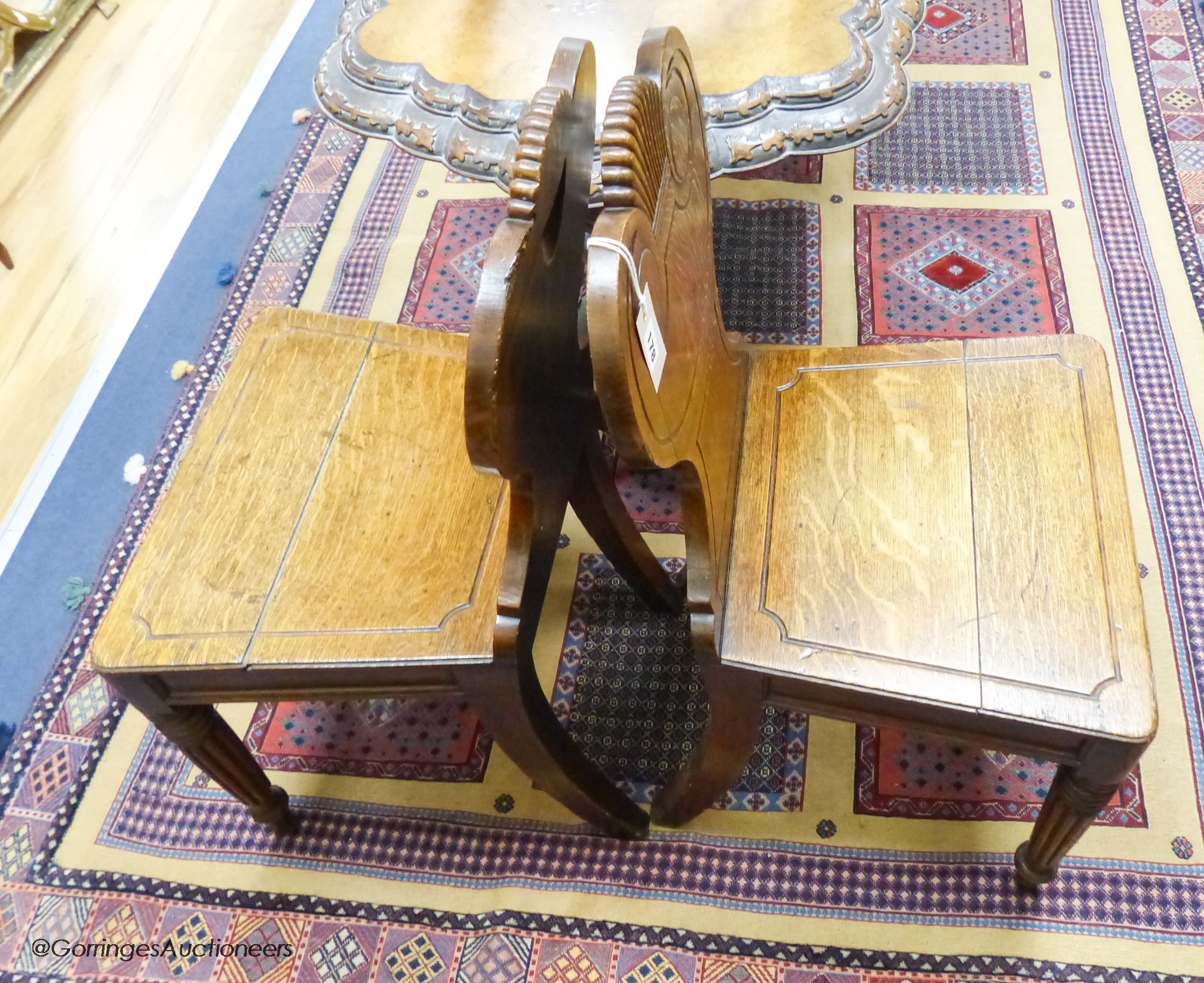 A pair of William IV oak hall chairs, stamped Gillows, Lancaster